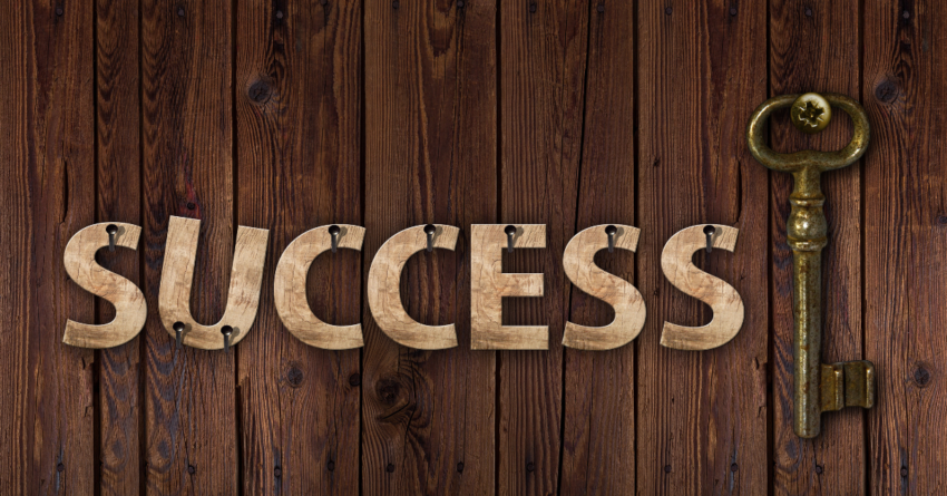 Brown Wood Canvas with Word Success Spread Across It